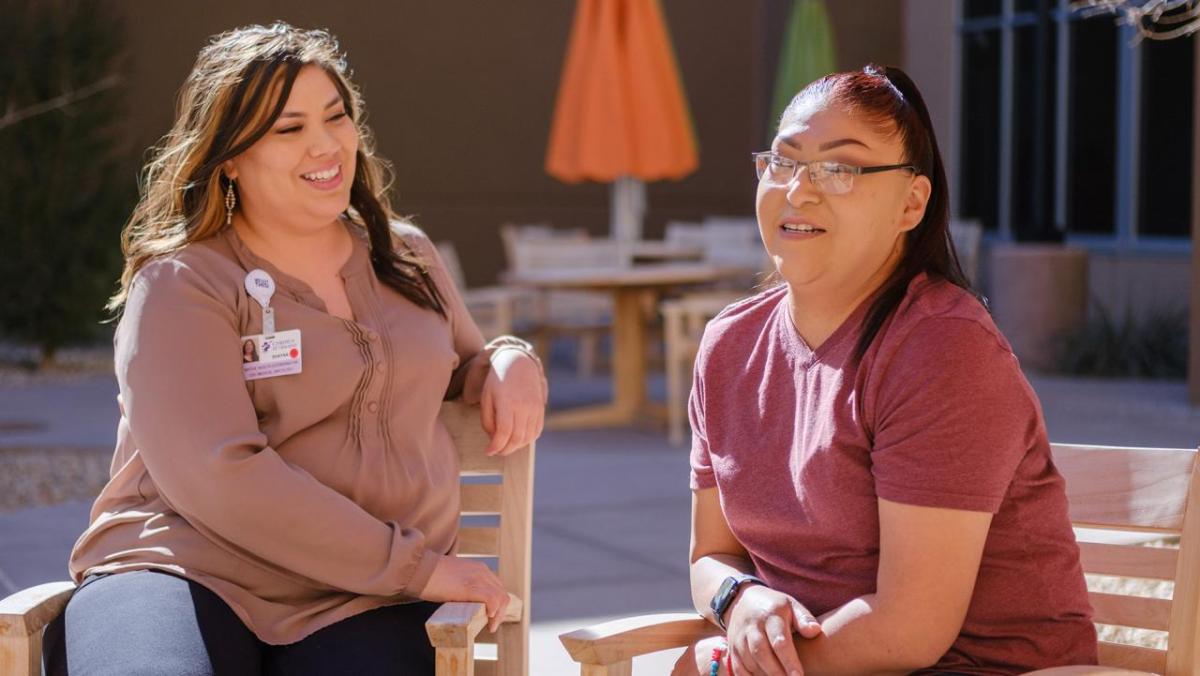 Photo of Native Health Navigator Shayna Grandbois-Herrera meeting with breast cancer patient Amy. " "